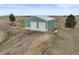 Detached two-car garage with white garage doors and a light green exterior at 2845 Cherry Way, Parker, CO 80138