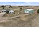 Aerial shot of the property featuring a home, garage, and expansive surrounding land at 2845 Cherry Way, Parker, CO 80138