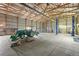 Large garage interior with tractor, car lift, and ample workspace for various projects at 2845 Cherry Way, Parker, CO 80138