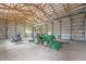 Spacious garage interior featuring a tractor, mower, and a vehicle lift system at 2845 Cherry Way, Parker, CO 80138