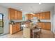 Modern kitchen with a central island, stainless steel appliances, granite counters, and wood cabinetry at 2845 Cherry Way, Parker, CO 80138