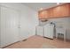Bright laundry room with washer, dryer, utility sink, and upper cabinets offers functionality and storage at 2845 Cherry Way, Parker, CO 80138