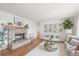 Inviting living room with a charming brick fireplace, stylish decor, and plenty of natural light at 2845 Cherry Way, Parker, CO 80138