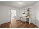 Bright home office featuring hardwood floors, built-in shelving, and a view into the living room at 2845 Cherry Way, Parker, CO 80138
