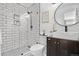 Modern bathroom featuring sleek walk-in shower, stylish vanity, and round mirror at 5155 W 68Th Ave # 5, Westminster, CO 80030