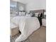 Bedroom with queen size bed, tufted headboard, and white bedding at 5155 W 68Th Ave # 5, Westminster, CO 80030
