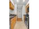 Long Galley kitchen featuring stainless steel appliances and plenty of cabinets at 5155 W 68Th Ave # 5, Westminster, CO 80030