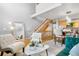 Open-concept living room featuring modern furniture, stylish decor, staircase, and open kitchen and dining area at 5155 W 68Th Ave # 5, Westminster, CO 80030
