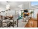 Open concept living room featuring a fireplace, staircase, dining table, and modern decor at 5155 W 68Th Ave # 5, Westminster, CO 80030
