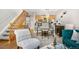 Cozy living room with adjacent dining area, staircase, and modern kitchen provides a harmonious and functional living space at 5155 W 68Th Ave # 5, Westminster, CO 80030