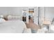 Bright bedroom featuring a bed, a crib, an ensuite bathroom, and natural light at 5155 W 68Th Ave # 5, Westminster, CO 80030