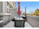 Outdoor patio set covered in snow with an umbrella and grill, creating a cozy and inviting outdoor space at 5155 W 68Th Ave # 5, Westminster, CO 80030