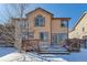 House exterior with large deck and snowy yard at 5416 S Gray St, Littleton, CO 80123