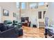 Spacious living room featuring hardwood floors, a large TV, and comfortable seating at 5416 S Gray St, Littleton, CO 80123
