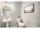 Modern half bath featuring a pedestal sink, sleek fixtures, and contemporary decor at 1011 White Leaf Cir, Castle Rock, CO 80108
