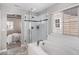 Bathroom featuring glass enclosed shower, white tiled walls, bathtub, and access to the primary bedroom at 1011 White Leaf Cir, Castle Rock, CO 80108