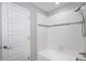 Bathroom featuring white tile surround, decorative accent tile, modern showerhead, and shower niche at 1011 White Leaf Cir, Castle Rock, CO 80108