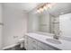 Bathroom featuring white cabinets and counters, tile floors, and modern vanity lighting at 1011 White Leaf Cir, Castle Rock, CO 80108