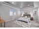 Bedroom boasts a trey ceiling, plush carpet, neutral walls, and ample natural light from the large window at 1011 White Leaf Cir, Castle Rock, CO 80108