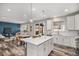 Modern kitchen with stainless steel appliances, white cabinets, and a quartz island at 1011 White Leaf Cir, Castle Rock, CO 80108