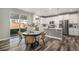 Bright eat-in kitchen featuring white cabinets, stainless steel appliances, and backyard access at 1011 White Leaf Cir, Castle Rock, CO 80108