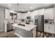 Well-equipped kitchen showcasing white cabinetry, stainless steel appliances, and a large island at 1011 White Leaf Cir, Castle Rock, CO 80108
