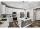 Bright kitchen with white cabinets, quartz countertops, and stainless steel appliances at 1011 White Leaf Cir, Castle Rock, CO 80108