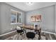Dedicated home office with a wooden desk, plush chairs, and ample natural light at 1011 White Leaf Cir, Castle Rock, CO 80108