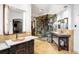 Luxurious bathroom featuring dual vanities and glass enclosed shower with decorative marble wall at 1 Canon Pl, Greenwood Village, CO 80111