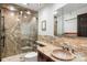 The updated bathroom features a stand-up shower and a stone sink with an elegant mirror at 1 Canon Pl, Greenwood Village, CO 80111