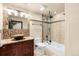 Bathroom features a vessel sink, granite countertop, and a tiled shower-tub combination at 1 Canon Pl, Greenwood Village, CO 80111