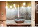 Contemporary bathroom features a stone vessel sink and decorative wall treatment and lighting at 1 Canon Pl, Greenwood Village, CO 80111