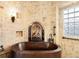 An elegant stone accent wall in the bathroom features a fireplace located above the bronze tub at 1 Canon Pl, Greenwood Village, CO 80111