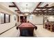 Game room featuring a billiards table, coffered ceilings, and easy access to the bar area at 1 Canon Pl, Greenwood Village, CO 80111