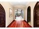 Inviting hallway with hardwood floors leads to a sun-lit living space with an accent stone wall at 1 Canon Pl, Greenwood Village, CO 80111