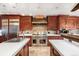 Gourmet kitchen features stone backsplash, stainless steel appliances, and marble countertops at 1 Canon Pl, Greenwood Village, CO 80111