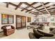 Spacious living room featuring coffered ceilings, plush seating, and direct access to the outdoors at 1 Canon Pl, Greenwood Village, CO 80111