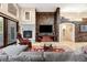 Comfortable living room features a stone accent wall with fireplace, and a view into the living space at 1 Canon Pl, Greenwood Village, CO 80111