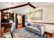 Home office offers wood floors, custom desk and cabinetry, overhead beams and comfortable couch at 1 Canon Pl, Greenwood Village, CO 80111