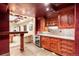 Convenient bar area with wood cabinets, wine storage, and views of adjacent game room at 1 Canon Pl, Greenwood Village, CO 80111