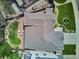 Aerial view of roof, patio with seating, and a well-maintained backyard featuring green grass and a hot tub at 7354 S Robb St, Littleton, CO 80127