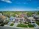 Aerial view of a well-manicured house with mature trees, lush lawn and scenic views in the background at 7354 S Robb St, Littleton, CO 80127
