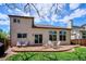 Backyard features a stamped concrete patio, dining set, lush lawn, and sliding glass doors at 7354 S Robb St, Littleton, CO 80127
