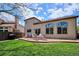 Backyard with a stamped patio, seating, manicured lawn and large windows that provides ample natural light at 7354 S Robb St, Littleton, CO 80127
