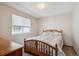 Cozy bedroom with warm light from a window and simple decor at 7354 S Robb St, Littleton, CO 80127