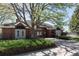 Charming brick clubhouse with manicured landscaping, featuring a mature tree and inviting entrance at 7354 S Robb St, Littleton, CO 80127