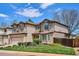 Charming two-story home with manicured lawn, mature landscaping, and neutral color palette at 7354 S Robb St, Littleton, CO 80127