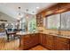Spacious kitchen featuring granite countertops, custom cabinets, and hardwood floors at 7354 S Robb St, Littleton, CO 80127