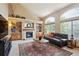 Inviting living room with fireplace, vaulted ceilings, and large windows at 7354 S Robb St, Littleton, CO 80127