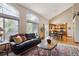 Bright living room featuring vaulted ceilings, a fireplace, and a seamless flow to the kitchen at 7354 S Robb St, Littleton, CO 80127